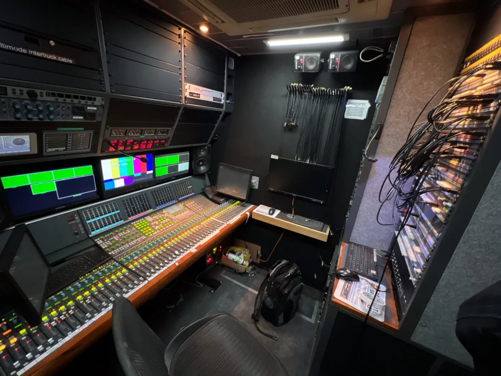 TRNSMT Festival Glasgow. Sound area of Cloudbass CBOB5 scanner (television outside broadcast vehicle) showing large format Calrec Omega sound desk, vision monitors, comms equipment and large patch panel. TV OB Sound Guarantee for King Tuts stage: Jamie Rhodes-Simpson