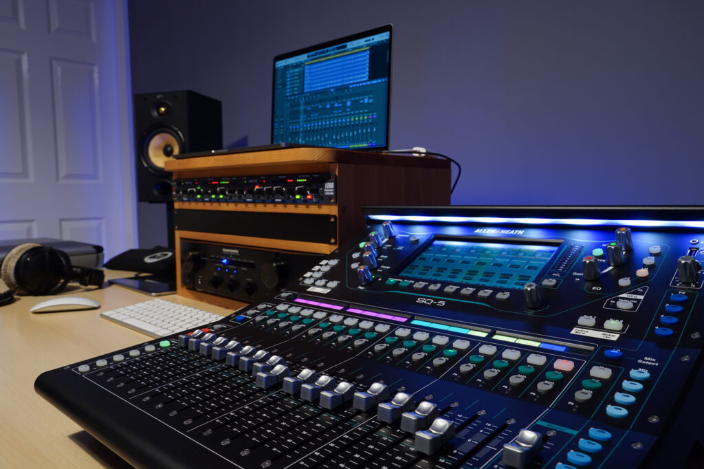 Photograph of the Capybara Sound studio mixing/mastering control position taken from an angle across the mixing desk, with B&W monitoring, Apple MacBook Pro running Logic Pro, Allen & Heath SQ-5 mixing console and some Beyerdynamic DT-770 Pro headphones. Also in the shot is a dbx 1066 analog dual compressor.