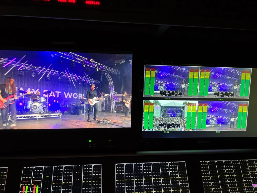 Video monitors above the TV sound console showing Jimmy Eat World performing on the King Tuts stage at Glasgow TRNSMT Festival.