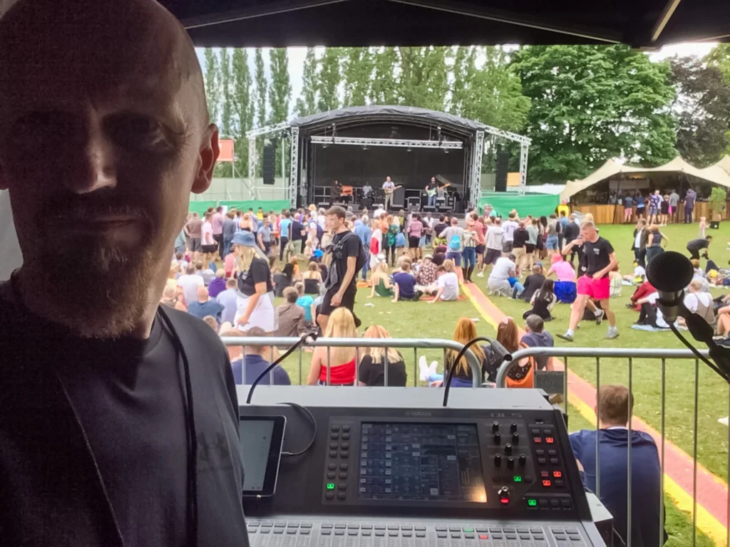 Sound engineer Jamie Rhodes-Simpson operating front of house sound for the Tramlines Festival Library stage (including BBC Introducing) in Sheffield. The mixing console is a Yamaha QL5. Large format NEXO line array PA system.